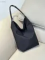 Black nylon hobo shoulder bag and lightweight bucket bag with chic handle design. - Black Strap / Black