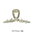 Gold metal hair claw clip with rhinestones and white floral charms for women elegant styling. - Gray