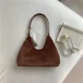 Brown plush shoulder bag detail showing soft faux fur texture, short strap, and elegant daily look. - Coffee