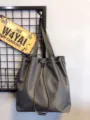 Detailed view of grey nylon drawstring tote bag highlighting dual straps and large capacity. - Gray