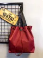 Wine red nylon drawstring tote bag detail, featuring durable shoulder straps and casual style. - Burgundy