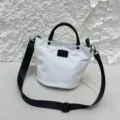 Waterproof nylon medium bucket bag with black handle and shoulder strap for casual daily use. - White