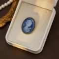 Vintage blue cameo brooch featuring a classic carved profile portrait with beaded metal rim frame. - Style 3 (Blue and White Relief)