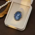 Vintage cameo brooch detail shot, elegant blue portrait in ornate silver box display. - Style 1