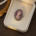 Vintage cameo brooch detail shot, ornate silver frame with purple relief portrait for elegant look - Style 2