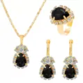 Close-up detail of luxury black gemstone jewelry set, sparkling crystals and gold metal finish. - Black