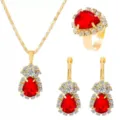 Detailed shot of luxury gold-plated red teardrop crystal necklace ring earrings jewelry set. - Red