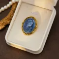 Vintage court style cameo brooch featuring an elegant blue portrait relief with gold frame. - Style 8