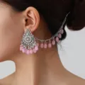 Detailed view of the bohemian style pink beaded ear chain and vintage silver earring piece. - Pink