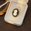 Vintage cameo brooch detail, classic black white relief lady profile in ornate gold tone frame. - Style 11
