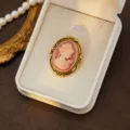 Vintage cameo brooch detail shot, elegant gold-toned frame with retro portrait relief for women. - Style 12