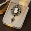 Vintage cameo brooch with silver filigree setting, sparkling rhinestones and elegant drop pendant. - Style 8