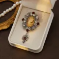 Vintage cameo brooch detail, medieval court style crystal rhinestone alloy jewelry close up. - Style 9