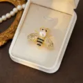 Elegant gold bee brooch featuring sparkling rhinestones and pearl detail for women fashion style. - Style 5