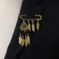 Vintage gold tone feather dangle brooch pin, bohemian ethnic style safety pin jewelry for women. - Black