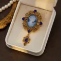 Close-up detail of vintage medieval cameo brooch, ornate gold filigree and sparkling rhinestones. - Style 5