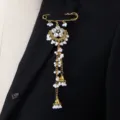 Exquisite southeast asian ethnic style rhinestone pearl tassel brooch detail view. - White