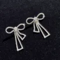 Close-up detail of sparkling rhinestone bow fringe earrings, exquisite craftsmanship and luxury style. - Style 2