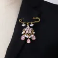 Gold-tone safety pin brooch with pink crystal rhinestones and faux pearls detail shot. - Pink