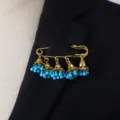 Vintage bohemian bell tassel brooch detail, gold tone pin with blue beaded charms accessory. - Blue