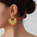 Ethnic Indian vintage tassel earrings, gold carved ear chain fashion jewelry detail view. - Golden Orange-Red