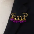 Retro bohemian style bell tassel brooch featuring golden safety pin and purple bead charms. - Purple