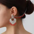 Detailed view of vintage ethnic silver-plated filigree ear chain earring with red beaded fringe. - Silver Red