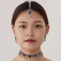 Detail shot of the ethnic vintage silver jewelry set featuring a chic choker, earrings and tikka. - Silver Black