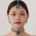 Detailed view of vintage Indian green crystal choker necklace earrings maang tikka set. - Silver and Green