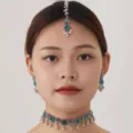 Detailed close-up of ethnic silver jewelry set featuring intricate metalwork and green crystal. - Silver Green