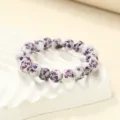 Exquisite ceramic bead bracelet with delicate purple floral pattern, elegant detail view. - Purple