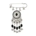 Close-up detail of vintage silver ethnic tassel brooch with sparkling crystals and black beads. - Black