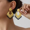 Vintage gold-tone geometric diamond-shaped earrings with black beaded fringe details. - Gold Black