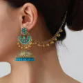 Detailed shot of ethnic gold-toned jhumka earring with turquoise beads and hair chain. - Blue