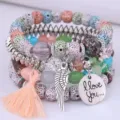 Close-up detail of boho multi-layer beaded bracelet set with tassel and feather charms. - Assorted Colors
