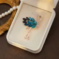 Elegant flamingo brooch crafted with sparkling blue crystals and rhinestones, gold tone. - Style 5