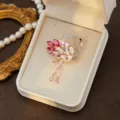 Close-up detail of a sparkling pink crystal flamingo brooch displayed in an elegant jewelry box. - Style 8