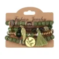 Bohemian multi-layer beaded bracelet set featuring green lava stones, charms, and tassel. - Green