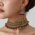 Close up detail of ethnic gold choker necklace and matching jhumka earrings with purple beads. - Gold and Purple