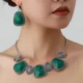 Detailed close-up view of a retro green stone necklace and matching drop earrings set. - Silver Green