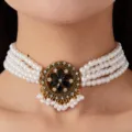 Close-up view of the multi-strand pearl choker necklace with vintage crystal flower pendant. - Black