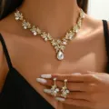 Close-up of luxury bridal crystal rhinestone floral necklace and matching earrings set. - Gold