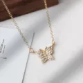 Gold butterfly necklace detailed shot, sparkling rhinestone pendant with delicate chain. - Butterfly Rhinestone Necklace / Gold