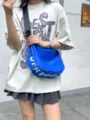 Detail view of the stylish blue crescent crossbody bag with adjustable strap for daily casual wear. - Blue