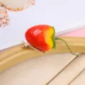 Close-up of cute 3D strawberry hairpin with realistic fruit design and secure metal clip. - Strawberry