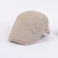 Khaki flat cap detail shot, stylish cotton newsboy hat featuring side embroidery and badge. - Adjustable / Beige