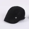 Black cotton flat cap for men, stylish retro ivy beret hat with metal badge and side text. - Adjustable / Black