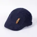 Detailed close-up of the stylish dark blue flat cap with decorative leather strap and buckle. - Adjustable / C - Navy Blue