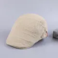Men's casual cotton flat cap newsboy hat detail view showcasing retro distressed grid pattern. - Adjustable / Beige