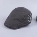 Close-up detail of the dark grey cotton flat cap with side embroidered fashion patch style. - Adjustable / Dark Gray